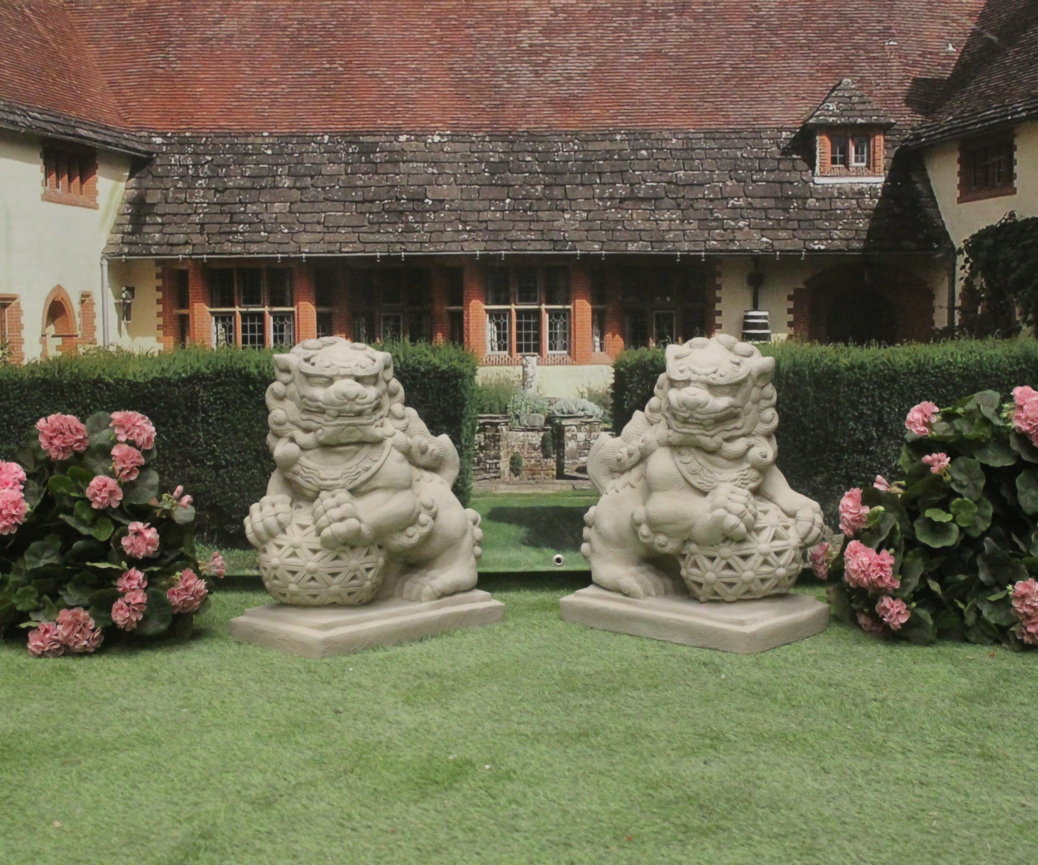 Pair of large Chinese foo dogs in reconstituted stone