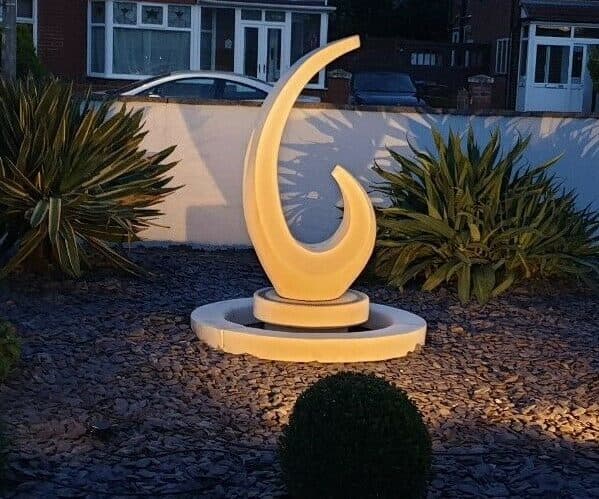 Shard sculpture fountain with sump and decorative surround